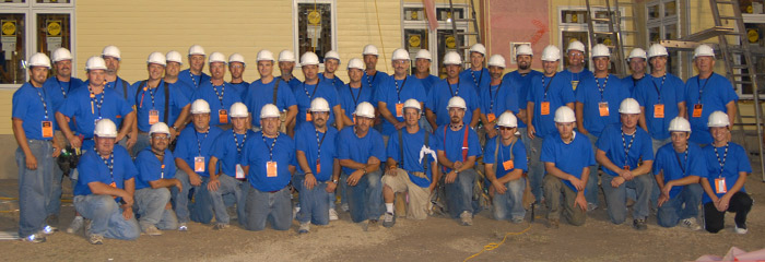 large gathering of Western Products employees wearing blue shirts and white hard hats