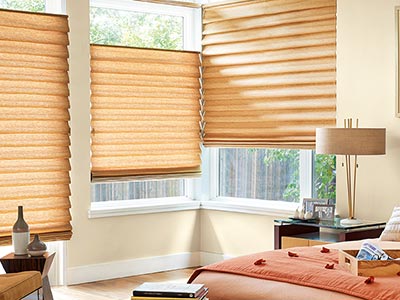 bedroom interior with tan roman shades