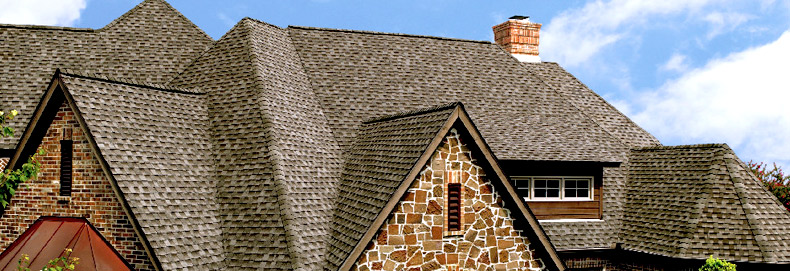 gray roofing on stone home