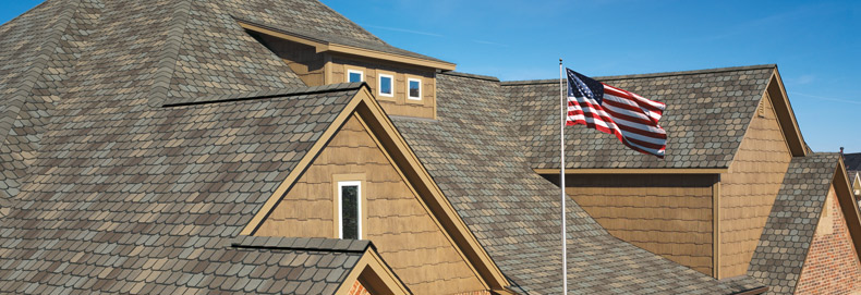 completed roof installment by Western Products with an American flag in the foreground