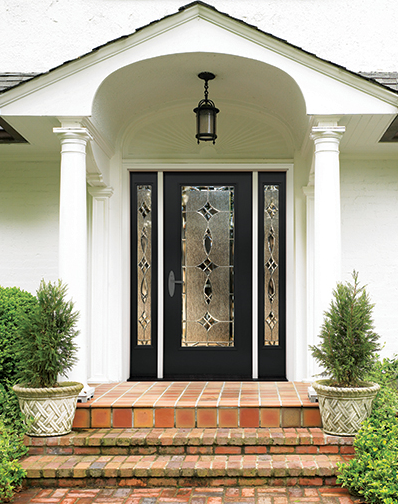 dark Therma-Tru door with three decorative windows on white house