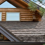 log building featuring detailing of dark brown stone-coated metal shake roofing