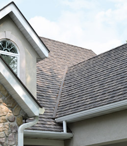home exterior featuring detailing on dark gray stone-coated metal shingle roofing