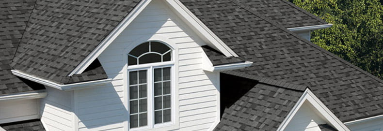 gray Owens Corning asphalt shingles on white home