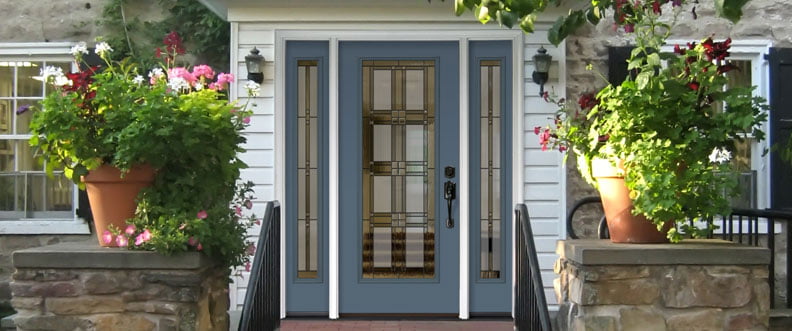 ProViaDoors_Legacy_792x331 blue ProVia door with three decorative windows on a white house