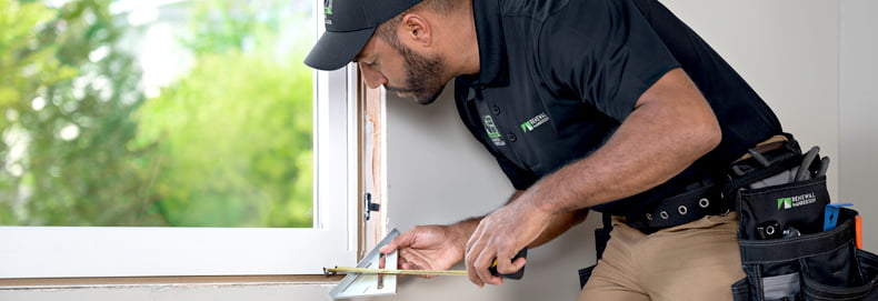 installer adjusts replacement Renewal by Andersen window