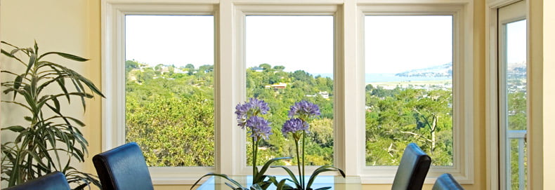 home interior dining room with four large picture windows showing a beautiful landscape