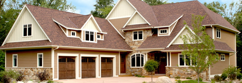 home exterior featuring brown-toned steel siding and lighter steel siding accents