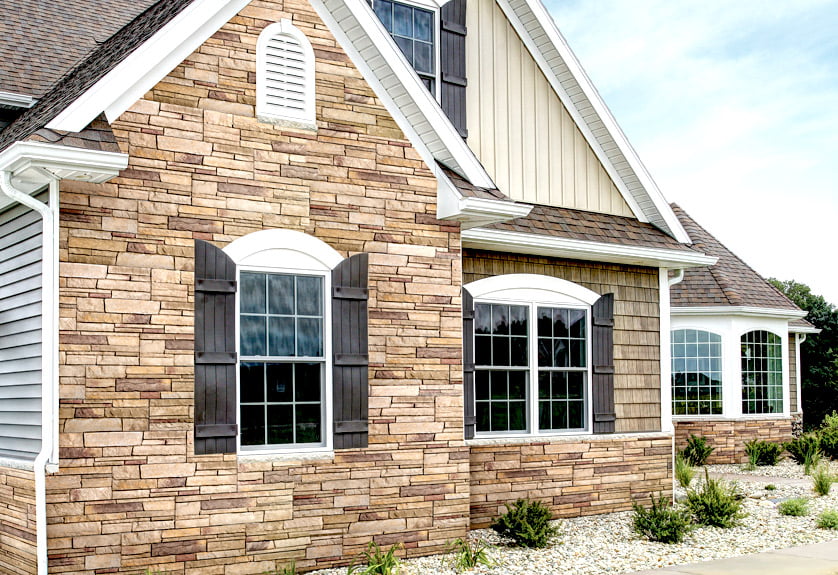 medium shot of home exterior featuring tan tight-cut Versetta stone siding on home exterior