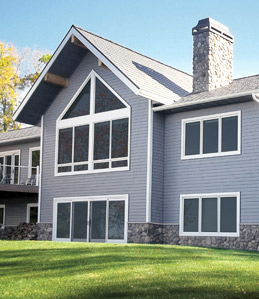 home exterior featuring light gray United States Seamless Siding with white trim and large windows