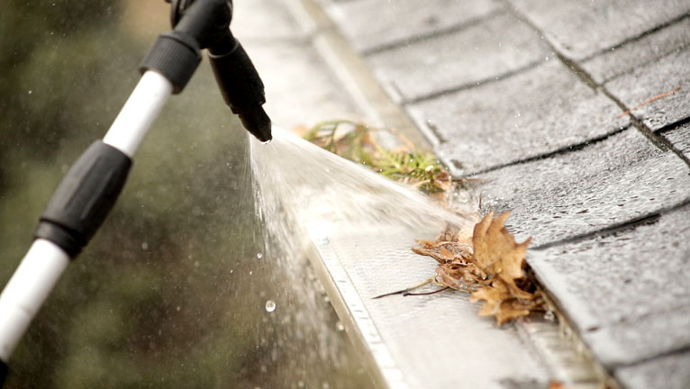 close up of Gutter Gekko cleaning with hose