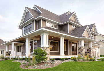 LPSmartSide_362x248 home exterior featuring tan LP SmartSide siding in both horizontal and decorative vertical patterns with white trim