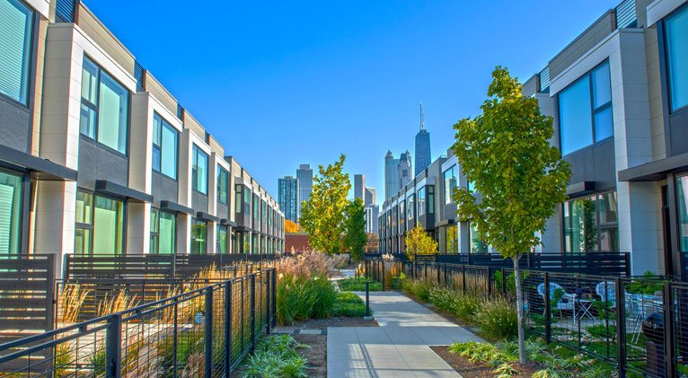 wide shot of apartment buildings featuring nichiha fiber cement siding and a skyline in the background