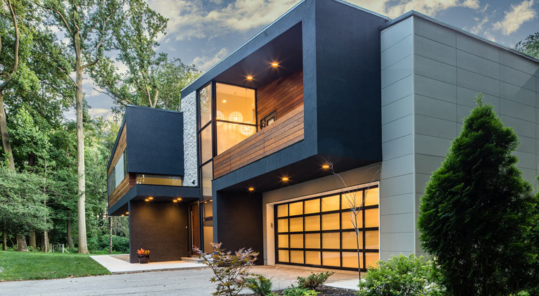 modern home exterior with dark nichiha fiber cement siding and large windows