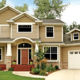 tan home exterior with seamless steel siding, gray roof, and white accents