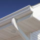 close up of white seamless steel siding, featuring soffit, fascia, gutter, and downspout