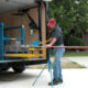 Western Products worker cuts seamless steel siding to unique length of home