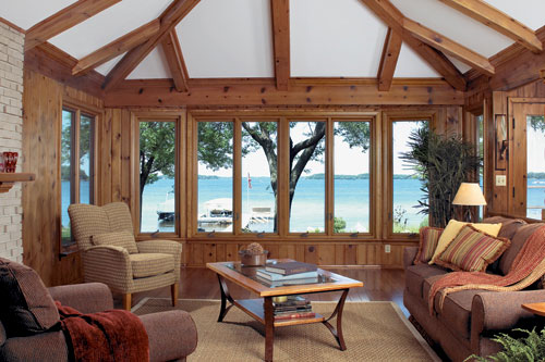 home interior living room casement windows showing lake shore outside