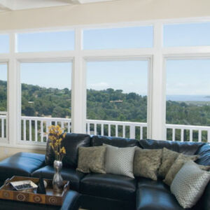 four large home interior living room picture windows showcase balcony and landscape