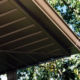 close up of tan soffit with tree in background