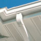 close up of white soffit with vents and gutter