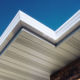 close up of white soffit with vents and fascia on a brick house