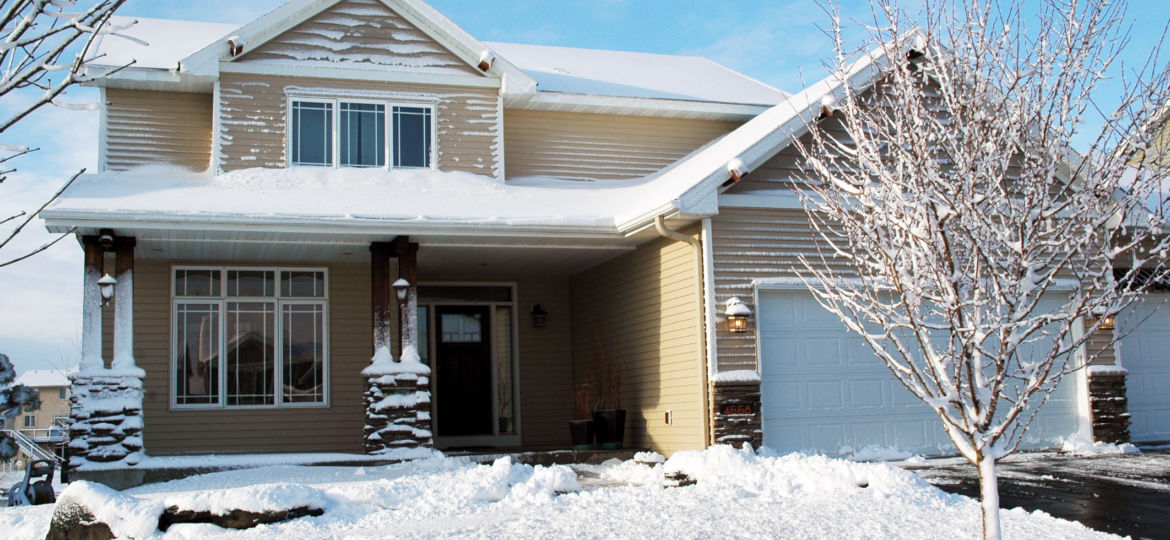 Exterior home with Renewal by Andersen windows, seamless siding and snow