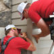 Western Products workers installing seamless steel siding