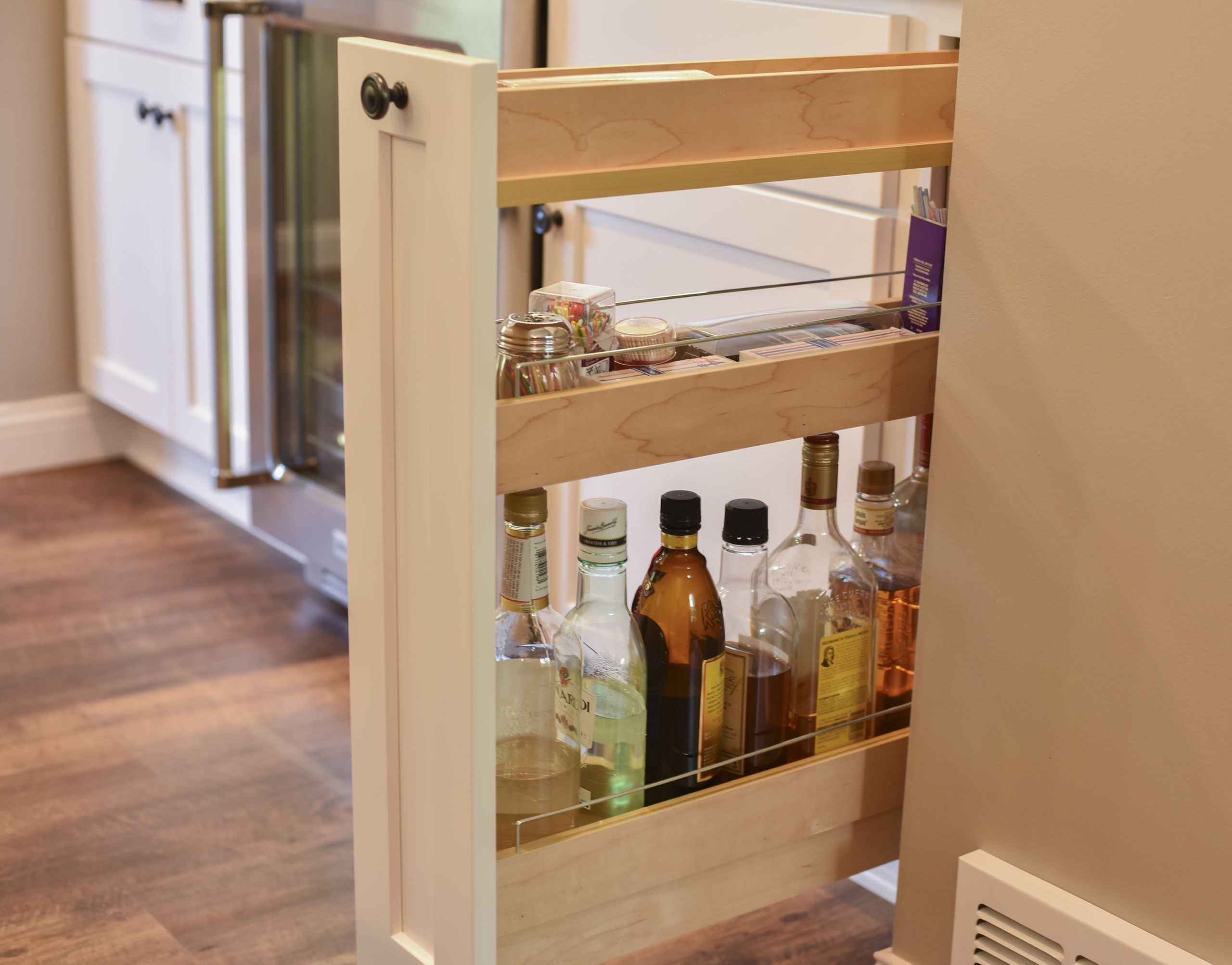 small kitchen space featuring narrow base cabinet drawer with three storage levels