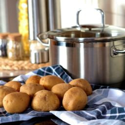 Potatoes in a kitchen next to a pot